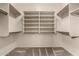 Walk-in closet featuring custom shelving and neutral carpeting at 3028 W Parkside Ln, Phoenix, AZ 85027