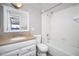 Bright bathroom with white cabinets, granite counters, and a shower-tub combo at 3230 E Pinchot Ave # 32, Phoenix, AZ 85018