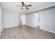 Bright bedroom featuring hardwood floors, ceiling fan, and multiple closets at 3230 E Pinchot Ave # 32, Phoenix, AZ 85018