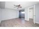Bright bedroom featuring hardwood floors, ceiling fan, and sliding glass door leading to the outdoors at 3230 E Pinchot Ave # 32, Phoenix, AZ 85018