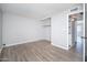 Spacious bedroom with built-in shelving, neutral paint, and plank flooring at 3230 E Pinchot Ave # 32, Phoenix, AZ 85018