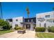 Sierra Grande building exterior with palm trees and manicured landscaping on a sunny day at 3230 E Pinchot Ave # 32, Phoenix, AZ 85018
