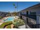 Balcony view of community pool, landscaping and building exterior on a bright, sunny day at 3230 E Pinchot Ave # 32, Phoenix, AZ 85018