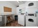 Community laundry facility with coin operated machines and seating area at 3230 E Pinchot Ave # 32, Phoenix, AZ 85018