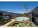 Beautiful community pool surrounded by lush landscaping, lounge chairs, and shade umbrellas at 3230 E Pinchot Ave # 32, Phoenix, AZ 85018