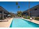 Sparkling pool surrounded by lounge chairs and tropical palm trees within the community at 3230 E Pinchot Ave # 32, Phoenix, AZ 85018