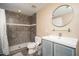 Updated bathroom features a shower with decorative tile and a modern sink with ample counter space at 327 E Monte Way, Phoenix, AZ 85042