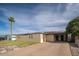 Exterior angle shot of a house featuring low-water landscaping and a long driveway at 327 E Monte Way, Phoenix, AZ 85042