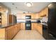 Well-equipped kitchen with sleek appliances, ample counter space, and natural wood cabinets, ideal for cooking and entertaining at 327 E Monte Way, Phoenix, AZ 85042