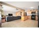 Open living room and kitchen area with wood accents, tile floors, and modern appliances, creating a spacious and inviting atmosphere at 327 E Monte Way, Phoenix, AZ 85042