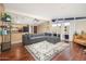 Bright living room with wood floors, large windows, and an open layout, perfect for entertaining and relaxation at 327 E Monte Way, Phoenix, AZ 85042