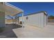 A shady backyard with a covered patio and metal storage shed with a table on a concrete slab at 3362 E Carol Ave, Mesa, AZ 85204