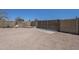 Fenced-in backyard features gravel, block wall, and gated entrance for privacy and security at 3362 E Carol Ave, Mesa, AZ 85204