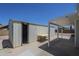 Backyard area featuring a metal shed with covered patio and a picnic table at 3362 E Carol Ave, Mesa, AZ 85204