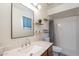 Bathroom with a wood vanity, large mirror, and a combined shower and tub area for all your needs at 3362 E Carol Ave, Mesa, AZ 85204