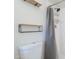 Close up of a bathroom featuring floating shelves and a shower with updated showerhead at 3362 E Carol Ave, Mesa, AZ 85204