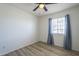 This cozy bedroom has wood-look floors and a window with curtains, creating a comfortable living space at 3362 E Carol Ave, Mesa, AZ 85204