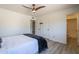 This bedroom features wood-look floors, a ceiling fan, and easy access to an adjoining bathroom at 3362 E Carol Ave, Mesa, AZ 85204