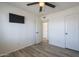 The bedroom boasts stylish wood-look flooring, a modern ceiling fan, and easy access to adjoining rooms at 3362 E Carol Ave, Mesa, AZ 85204