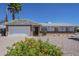 Charming single-story home with desert landscaping, two-car garage and brick accents at 3362 E Carol Ave, Mesa, AZ 85204