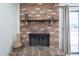Cozy brick fireplace with decorative mantle and hearth beside glass doors, adding warmth and charm to the space at 3362 E Carol Ave, Mesa, AZ 85204