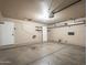 A clean garage featuring storage shelves, a side door, and concrete flooring perfect for organization and projects at 3362 E Carol Ave, Mesa, AZ 85204