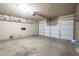 Spacious garage with an automatic door, shelving and concrete floors, ready for any project or parking at 3362 E Carol Ave, Mesa, AZ 85204