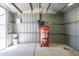 Organized garage with shelving, ample space for tools, and a red Husky air compressor at 3362 E Carol Ave, Mesa, AZ 85204