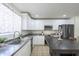 Bright kitchen features white cabinets, granite countertops, stainless steel appliances, and an island with seating at 3362 E Carol Ave, Mesa, AZ 85204