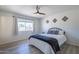 The main bedroom is bright, with wood-look flooring, and a large window to enjoy the Arizona sunshine at 3362 E Carol Ave, Mesa, AZ 85204