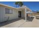 An inviting covered patio with a concrete floor, featuring palm trees and a partial block fence at 3362 E Carol Ave, Mesa, AZ 85204