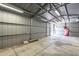 A large interior of a steel storage shed with lighting and concrete floors at 3362 E Carol Ave, Mesa, AZ 85204
