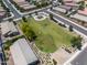 Aerial view of a neighborhood park with a playground and green space, surrounded by residential houses at 36515 N Takota Trl, San Tan Valley, AZ 85140