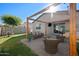 Relaxing outdoor space featuring a covered patio, a comfortable lounge area, and a lush green yard at 36515 N Takota Trl, San Tan Valley, AZ 85140