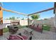 The backyard features a cozy seating area with string lights and a stone fire feature, creating a relaxing space at 36515 N Takota Trl, San Tan Valley, AZ 85140