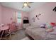 Bright pink bedroom featuring a desk, chair, and personal touches at 36515 N Takota Trl, San Tan Valley, AZ 85140