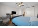 Cozy bedroom with barn door, desk and workstation setup at 36515 N Takota Trl, San Tan Valley, AZ 85140