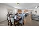 Inviting dining room seamlessly connected to the kitchen, featuring a stylish table set for a meal and modern decor at 36515 N Takota Trl, San Tan Valley, AZ 85140