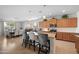 Open-concept kitchen featuring a large island with seating, stainless steel appliances, and seamless flow to the dining area at 36515 N Takota Trl, San Tan Valley, AZ 85140