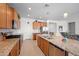 Well-designed kitchen features granite countertops, stainless steel appliances, a central island, and ample cabinet space at 36515 N Takota Trl, San Tan Valley, AZ 85140