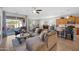 Open-concept living room features a comfortable sofa and seamless kitchen and dining area at 36515 N Takota Trl, San Tan Valley, AZ 85140