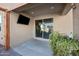 Covered patio boasts a mounted TV and seamless access to the indoors for entertainment and relaxation at 36515 N Takota Trl, San Tan Valley, AZ 85140