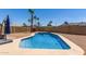 Inviting backyard featuring a refreshing pool, patio area with a firepit, and palm trees at 3765 W Wood Dr, Phoenix, AZ 85029