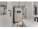 Modern bathroom with a tiled shower, shower niche, and gray tiled floors at 3765 W Wood Dr, Phoenix, AZ 85029