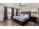 Spacious bedroom with a ceiling fan, wood floors, and a large window offering natural light at 3765 W Wood Dr, Phoenix, AZ 85029