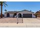 Single-story home with a well-maintained front yard, mailbox, and a two-car garage at 3765 W Wood Dr, Phoenix, AZ 85029