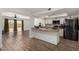Open kitchen and living area featuring stainless steel appliances, wood floors, and neutral countertops at 3765 W Wood Dr, Phoenix, AZ 85029