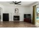 Bright living room featuring a fireplace, wood floors, and a sliding glass door to the backyard at 3765 W Wood Dr, Phoenix, AZ 85029
