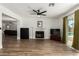 Spacious living room with fireplace, wood floors, and view of the backyard pool area at 3765 W Wood Dr, Phoenix, AZ 85029