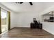 Bright living room with wood floors, desk area, and sliding doors to the backyard at 3765 W Wood Dr, Phoenix, AZ 85029